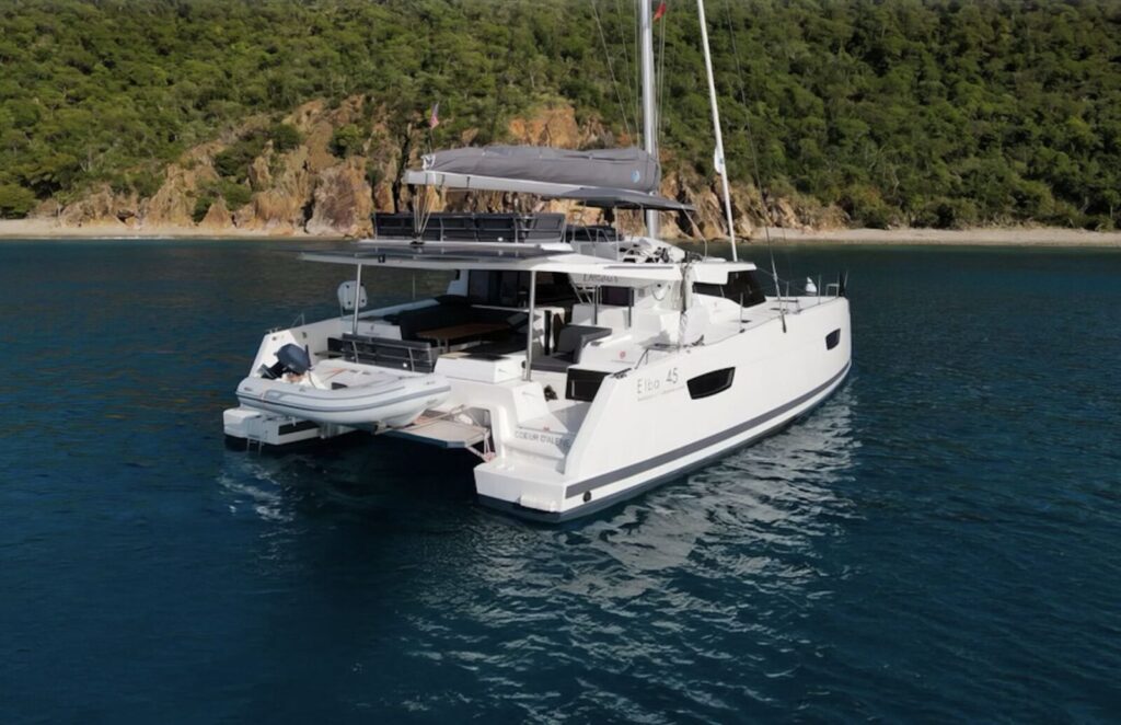 Catamaran at anchor on calm blue sea