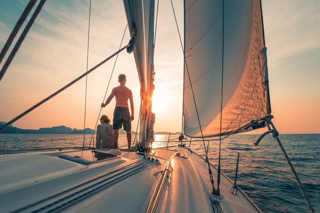 Sailboat under sail with a person at the bow