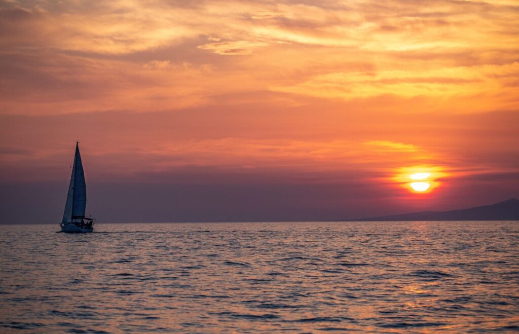 Sailboat at sunset on the open sea