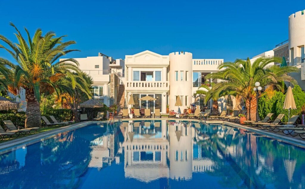 Resort pool with palm trees and hotel building
